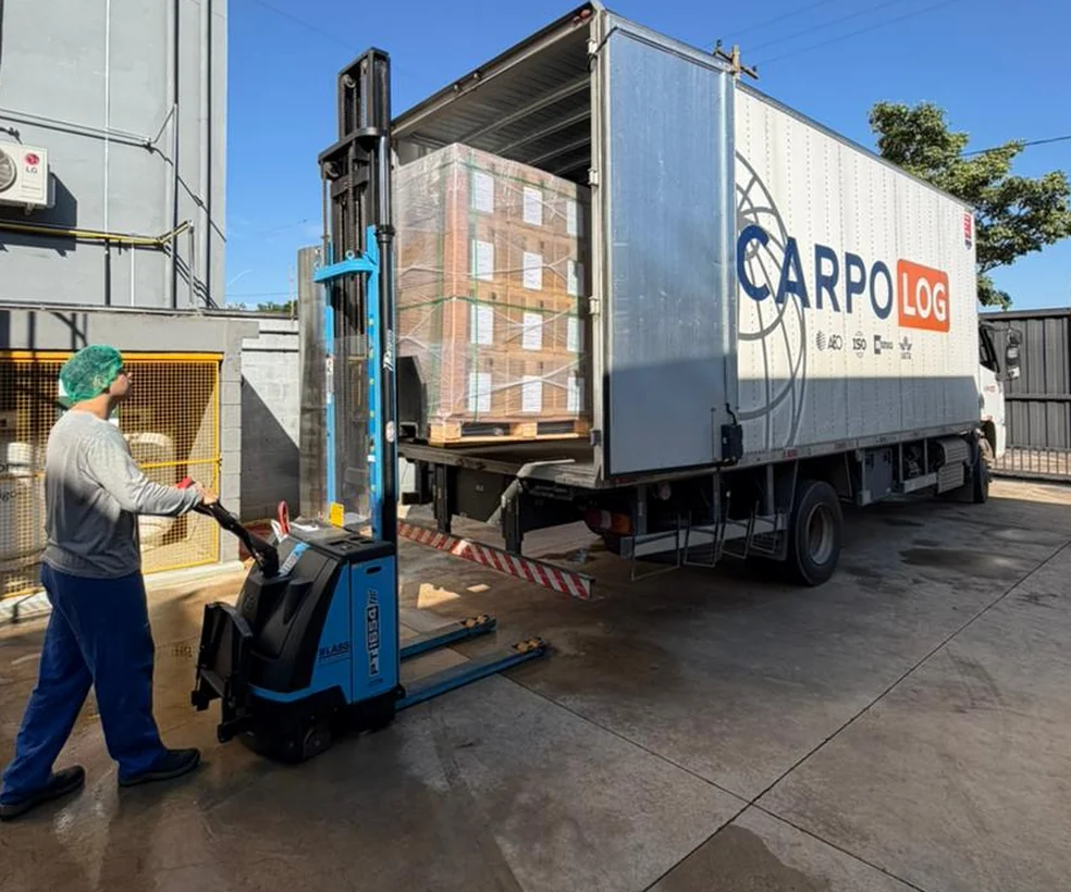 Photo of a pallet being unloaded from a delivery truck with a forklift